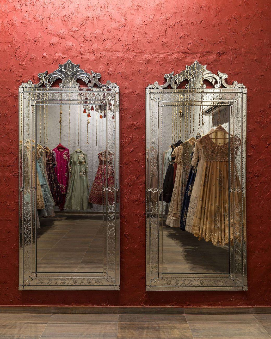 Racks of couture reflected between tall Venetian mirrors at Amiraah
