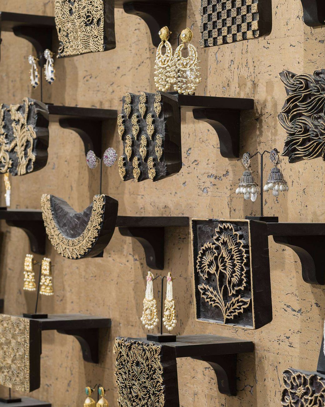 Gold and black heritage jewellery displayed in niches at Amiraah